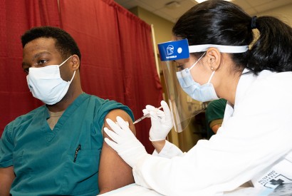 Army Cpt. Isaiah Horton, a doctor at Walter Reed National Military Medical Center, receives a COVID-19 vaccination, Walter Reed National Military Medical Center, Bethesda, Md. DoD photo by Lisa Ferdinando