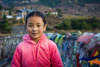 A young girl standing on the Punakha Suspension Bridge, Punakha, Bhutan. Gaurav Bagdi / Unsplash