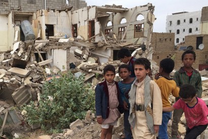 Young boys standing in front of damaged buildings in Saada, Yemen, where bombing has left many neighborhoods in the city are strewn with wreckage and debris following ground fighting between armed groups. Photo: WFP / Jonathan Dumont