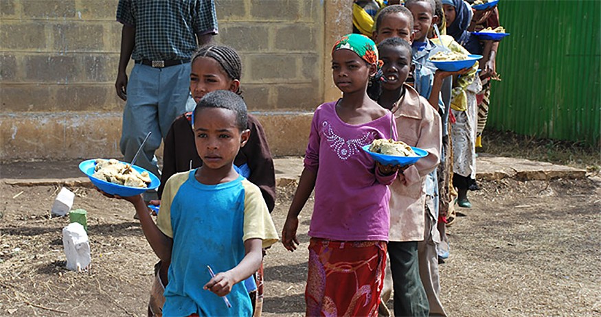 Ethiopian children carrying their food. Ethiopia is noted as making significant progress against poverty. Lillian deValcourt-Ayala/USUN Rome