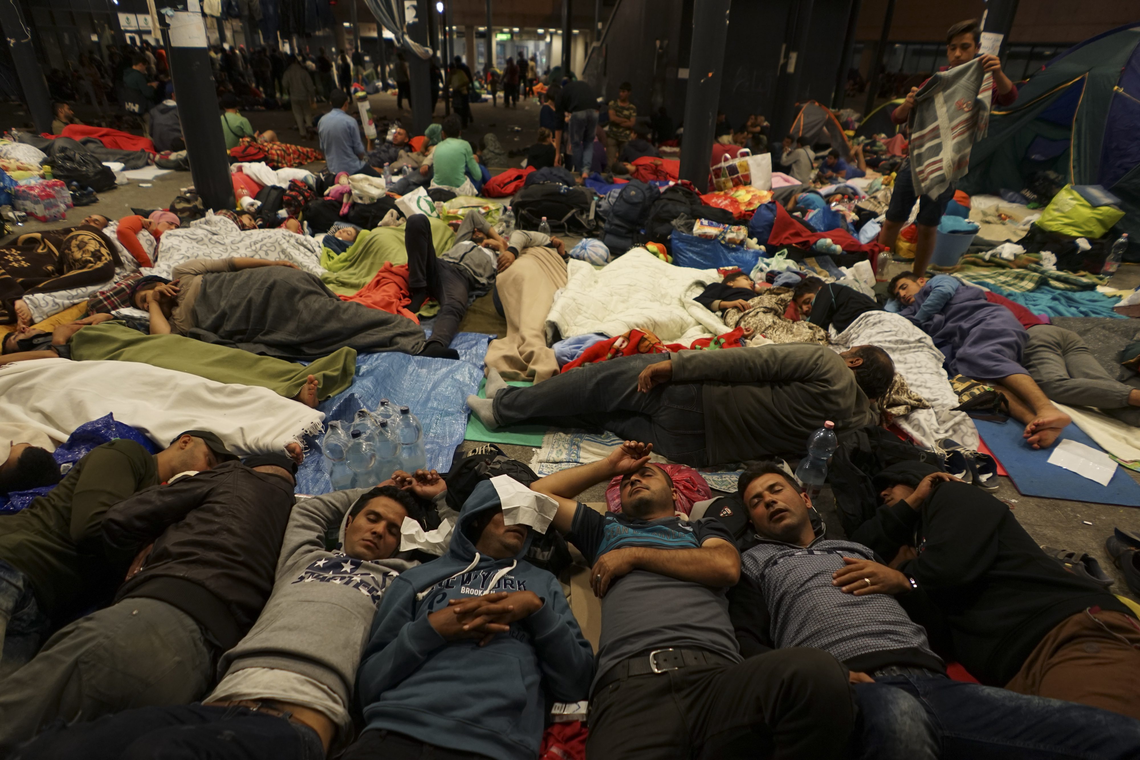 Syrian refugees resting on the floor at the Keleti railway station in Budapest, Hungary. Wikimedia Commons.