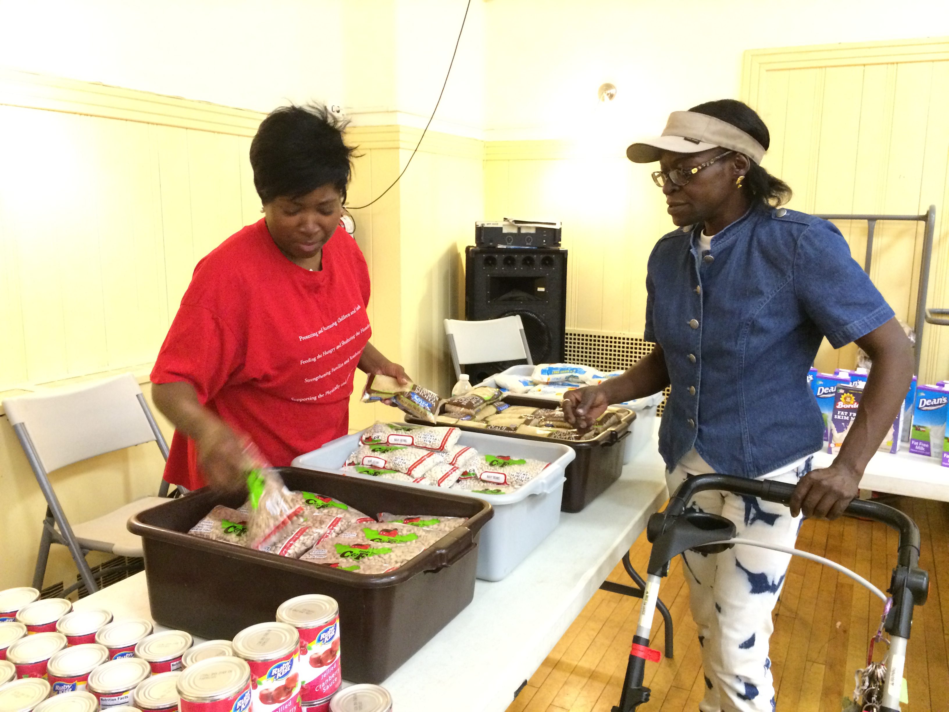 Susan La-Rose, right, visits the food pantry at Lt. Joseph P. Kennedy Community Center in Harlem. Margaret Tran/Bread for the World.