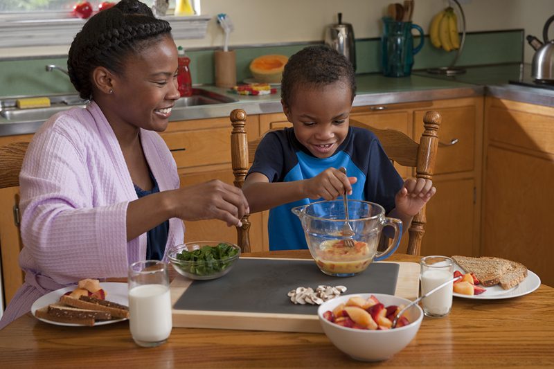 A mother and son prepare breakfast together. Photo courtesy of USDA.