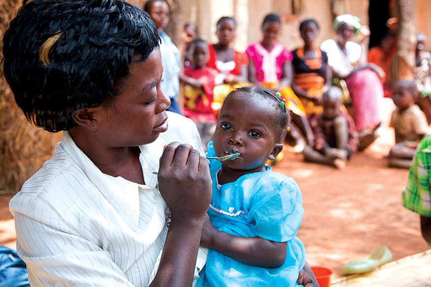 Mothers in a Zambian village learn how to prepare and feed their children a nutritious porridge. Photo: Joe Molieri / Bread for the World