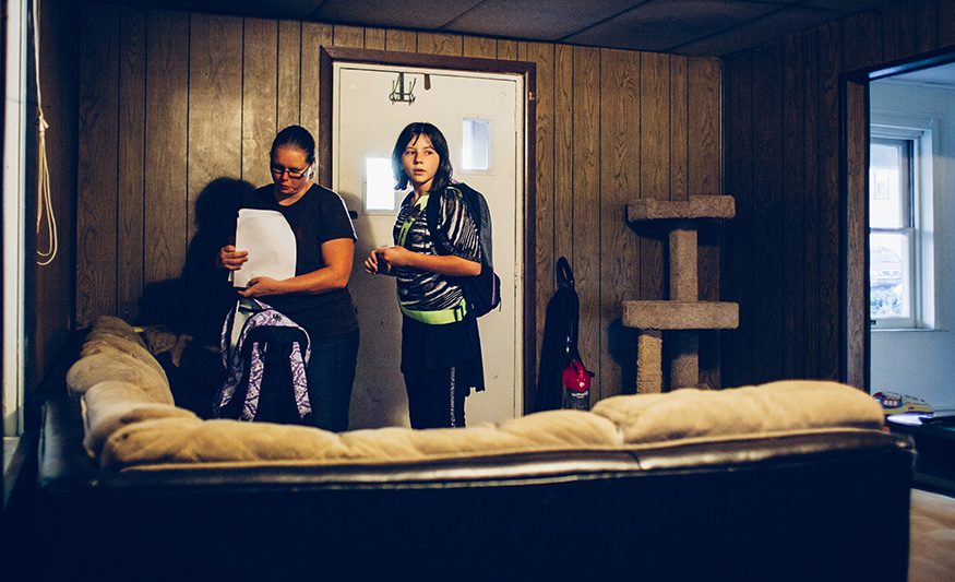 Arwen waits patiently while her mom checks to make sure she's got all of her homework finished before heading out the door to the bus stop. Joseph Terranova for Bread for the World.