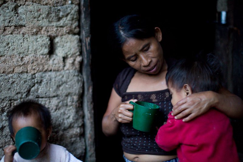 Catarina Pascual Jimenez (center) feeds her two twins. Joseph Molieri/Bread for the World.