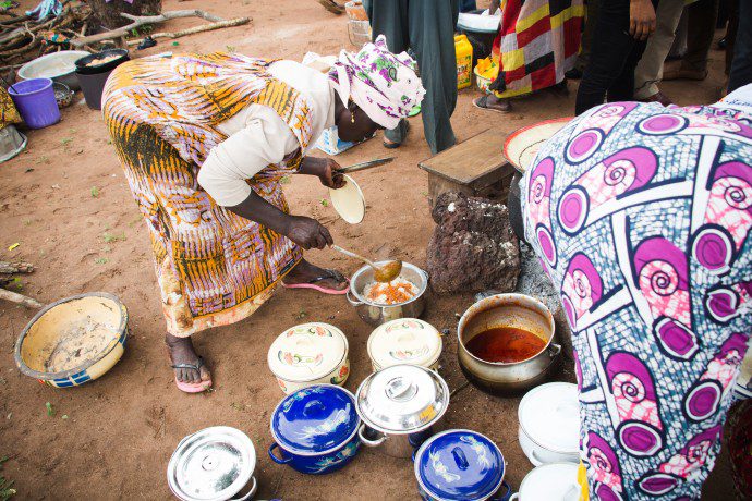 Women prepare a highly nutritious meal from the orange-fleshed sweet potato, a vitamin A-rich crop introduced in Northern Ghana. / USAID/Ghana