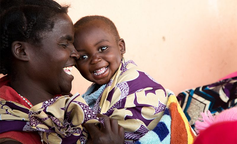 In rural Zambia, Dcsco Muyanda shares a moment of laughter with her son Berty. Photo: Joe Molieri / Bread for the World