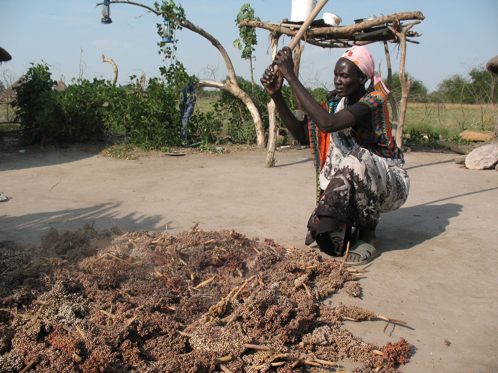 Dabora Nyibol, a returned refugee in South Sudan, prepares sorghum, a staple in her country. Bread for the World photo.