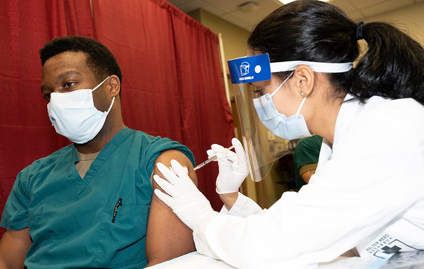 Army Cpt. Isaiah Horton, a doctor at Walter Reed National Military Medical Center, receives a COVID-19 vaccination, Walter Reed National Military Medical Center, Bethesda, Md. DoD photo by Lisa Ferdinando