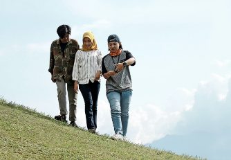 3 people on a hill
